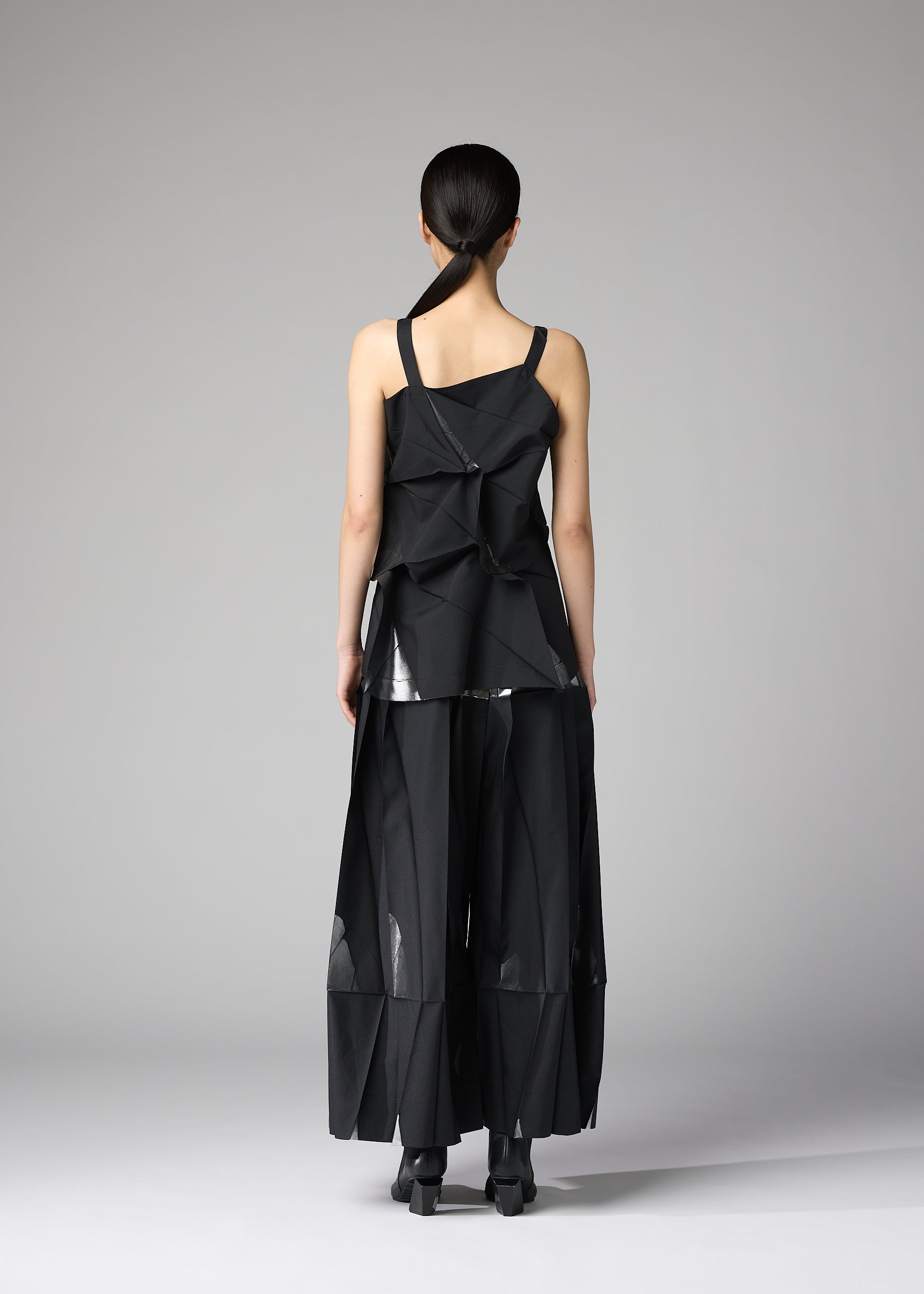 A model wears the 132 5. ISSEY MIYAKE No.1-1 shirt.