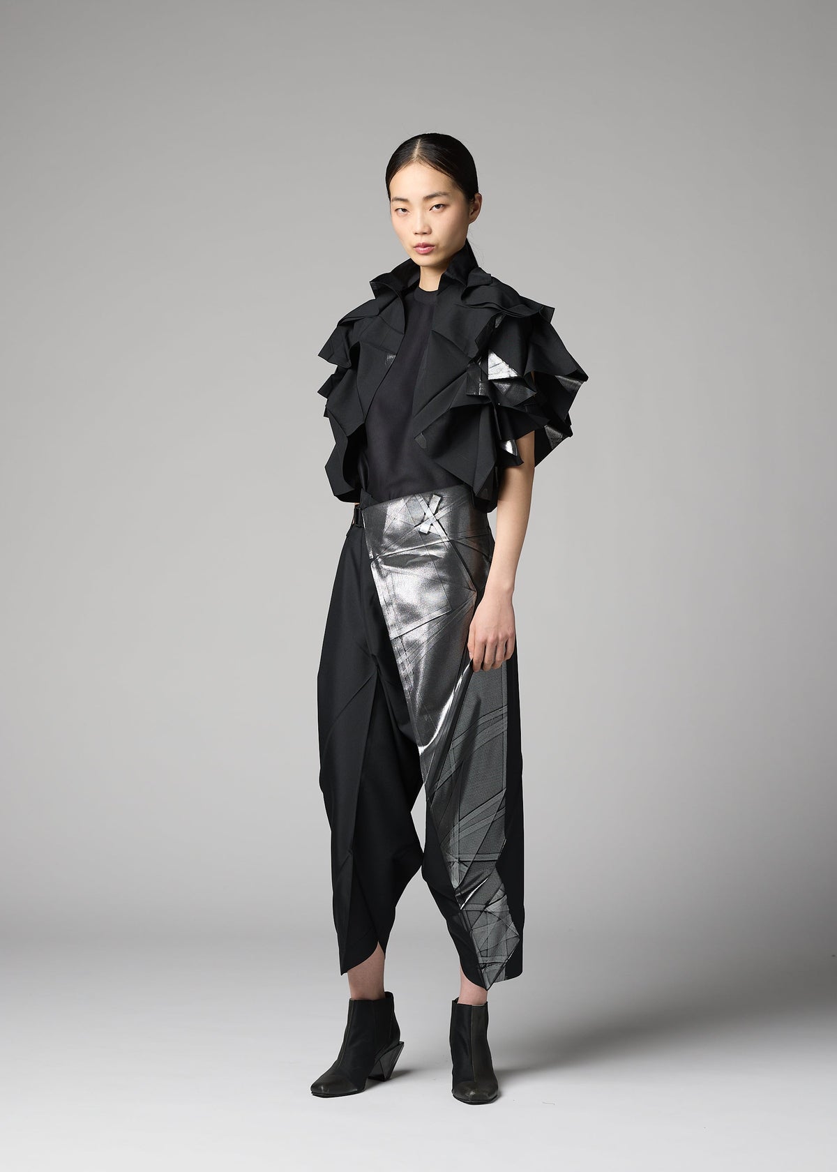 A model wears the 132 5. ISSEY MIYAKE No.10-1 cardigan.