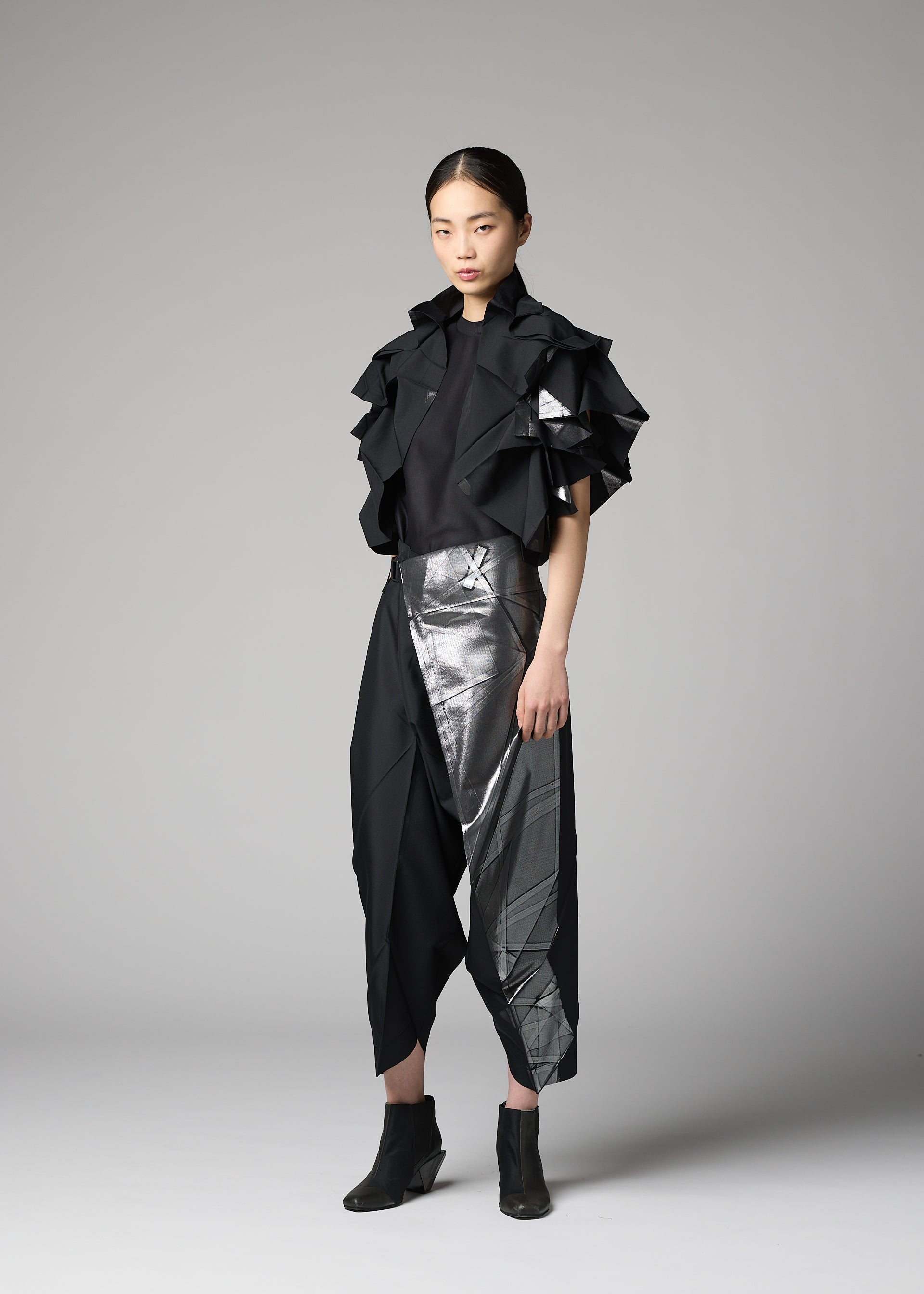 A model wears the 132 5. ISSEY MIYAKE No.10-1 cardigan.