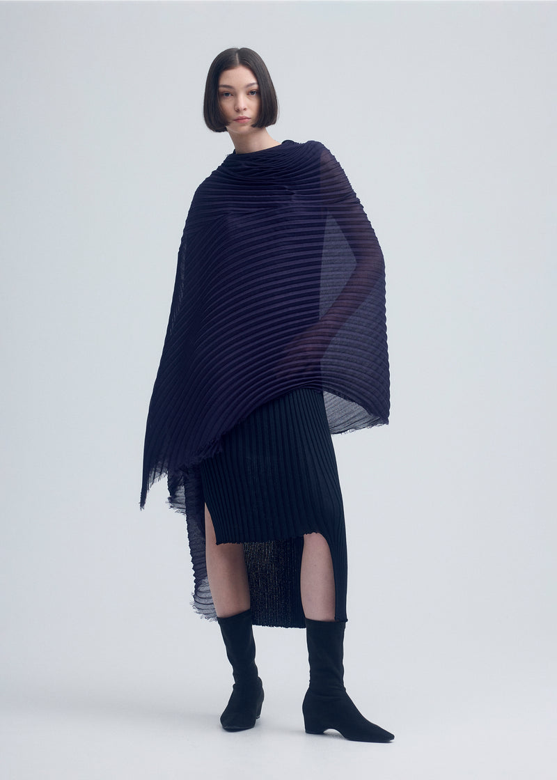 A model wears the ISSEY MIYAKE  SILK WOOL PLEATS STOLE stole