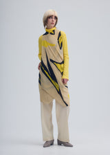 A model wears the ISSEY MIYAKE VIGOR PLEATS STOLE stole.