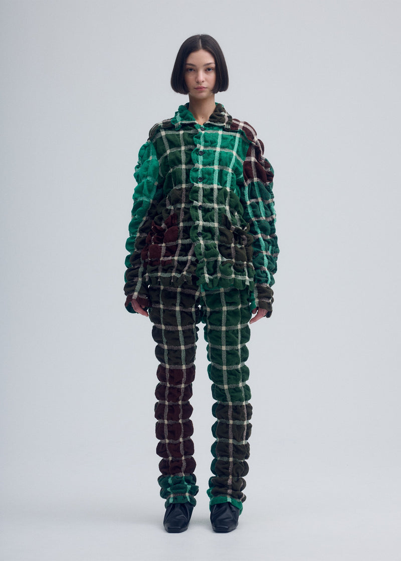 A model wears the ISSEY MIYAKE PRISM CHECK jacket.