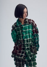 A model wears the ISSEY MIYAKE PRISM CHECK jacket.