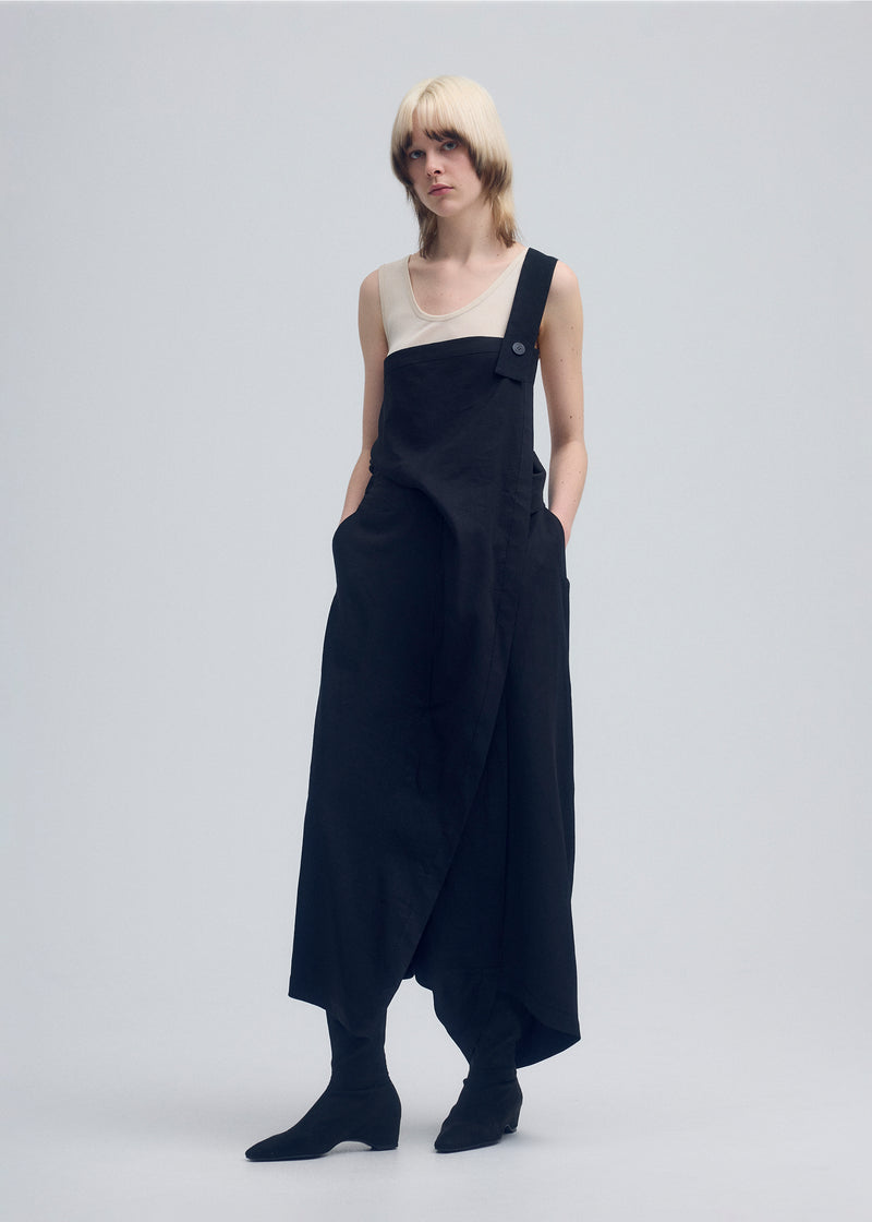 A model wears the ISSEY MIYAKE  ENCLOTHE PANTS trousers