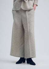 A model wears the ISSEY MIYAKE WARM PLEATS trousers.