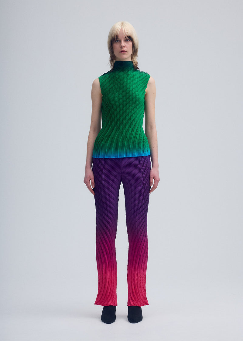 A model wears the ISSEY MIYAKE NUANCE PLEATS trousers.