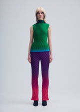 A model wears the ISSEY MIYAKE NUANCE PLEATS trousers.