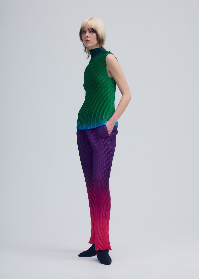 A model wears the ISSEY MIYAKE NUANCE PLEATS trousers.