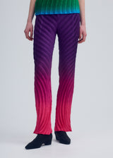 A model wears the ISSEY MIYAKE NUANCE PLEATS trousers.