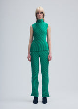 A model wears the ISSEY MIYAKE NUANCE PLEATS SOLID trousers.