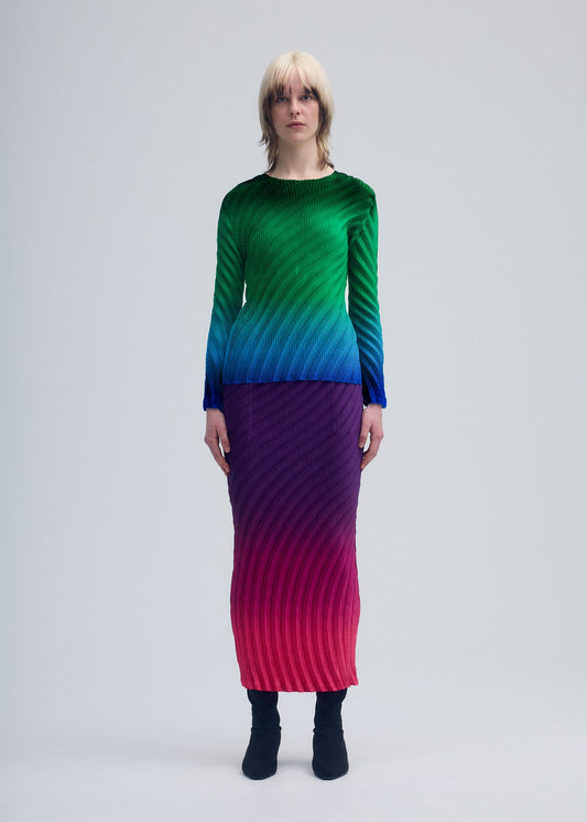 A model wears the ISSEY MIYAKE NUANCE PLEATS skirt.