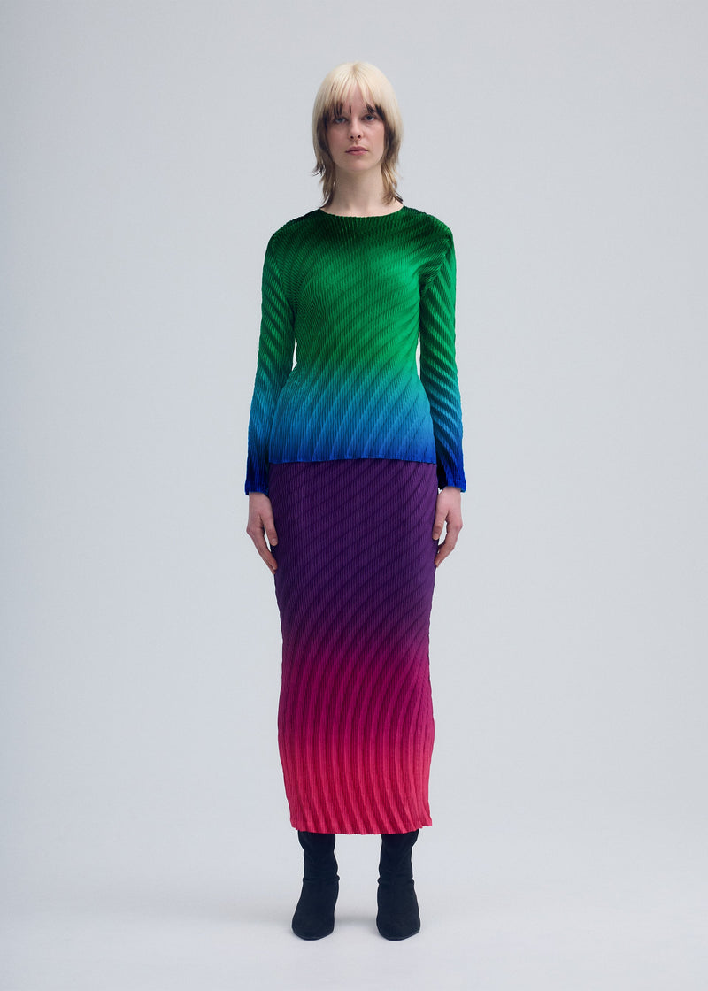 A model wears the ISSEY MIYAKE NUANCE PLEATS skirt.