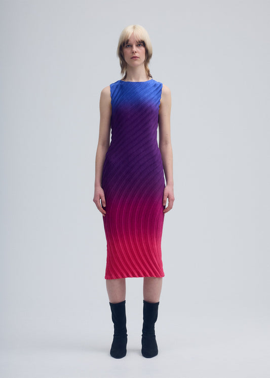 A model wears the ISSEY MIYAKE NUANCE PLEATS dress.