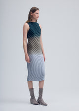 A model wears the ISSEY MIYAKE NUANCE PLEATS dress.