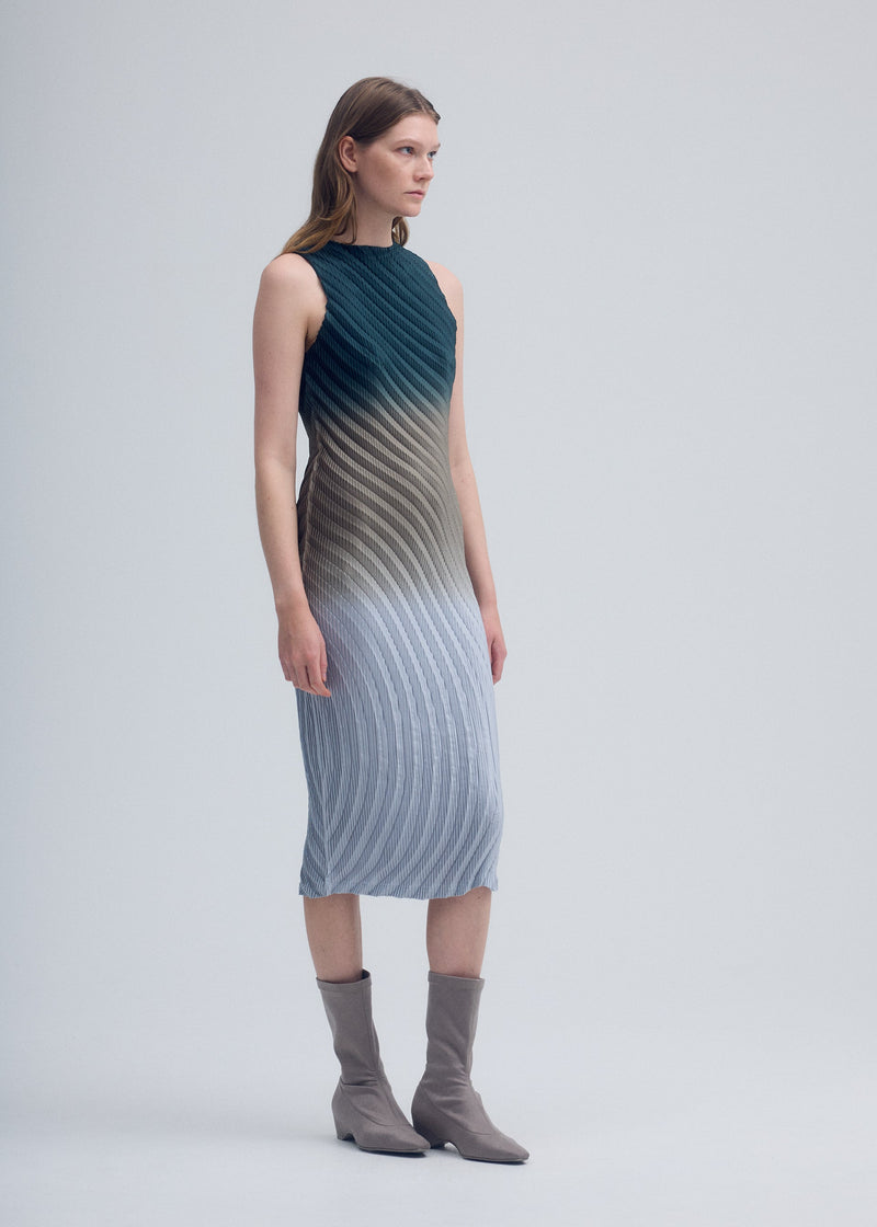 A model wears the ISSEY MIYAKE NUANCE PLEATS dress.