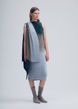 A model wears the ISSEY MIYAKE NUANCE PLEATS dress.