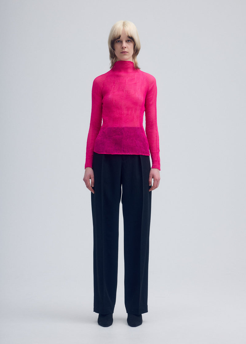 A model wears the ISSEY MIYAKE CHIFFON TWIST 3 top.