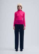 A model wears the ISSEY MIYAKE CHIFFON TWIST 3 top.