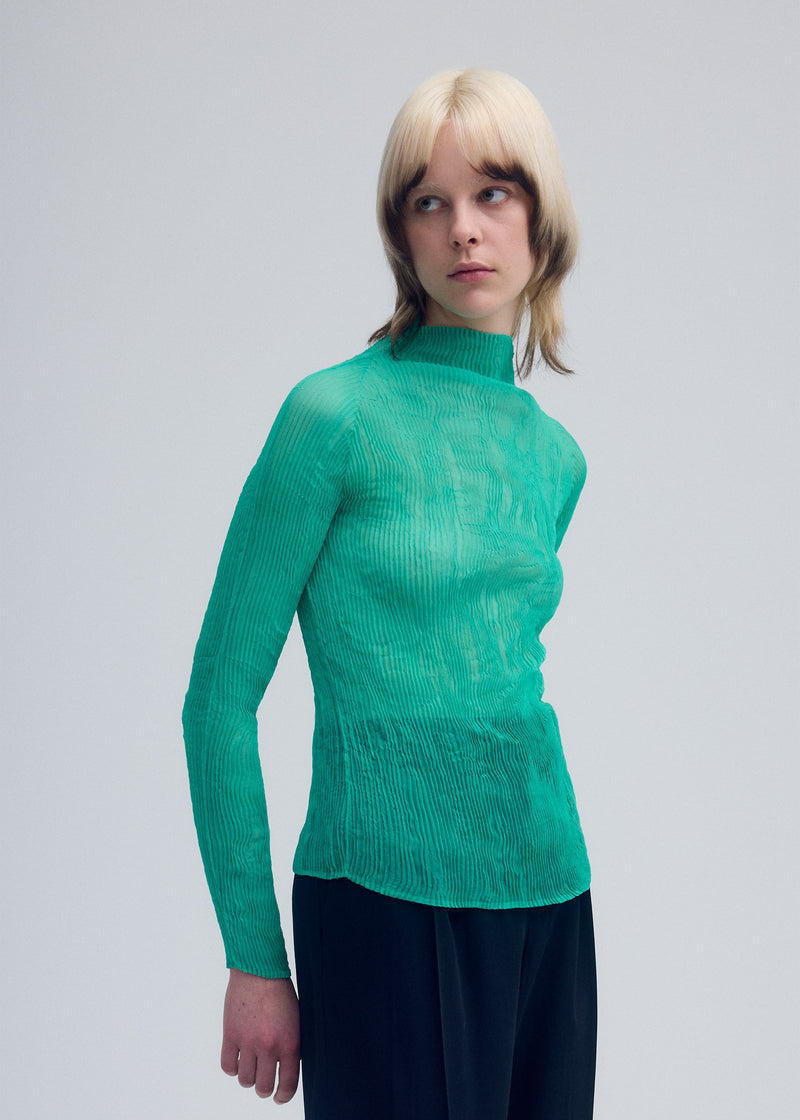 A model wears the ISSEY MIYAKE CHIFFON TWIST 3 top.