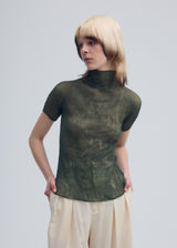 A model wears the ISSEY MIYAKE CHIFFON TWIST 3 top.