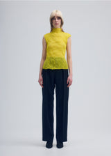 A model wears the ISSEY MIYAKE  CHIFFON TWIST 1 top