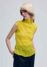 A model wears the ISSEY MIYAKE  CHIFFON TWIST 1 top