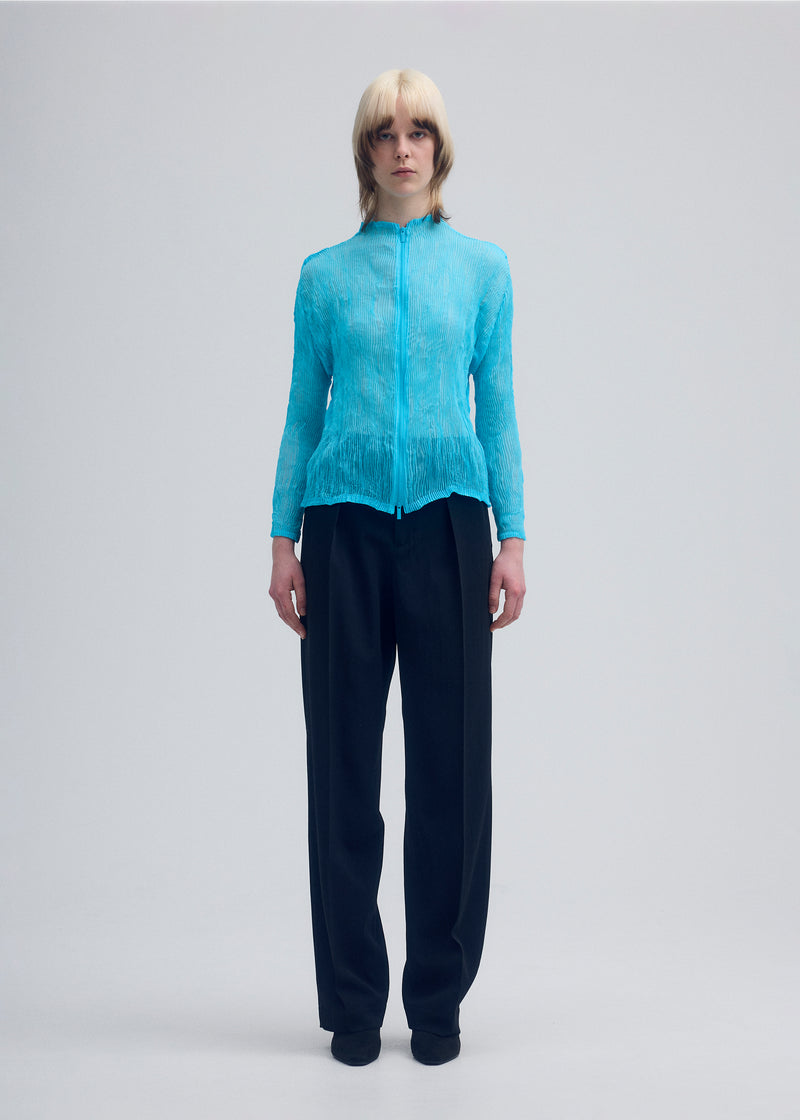 A model wears the ISSEY MIYAKE  CHIFFON TWIST 1 cardigan