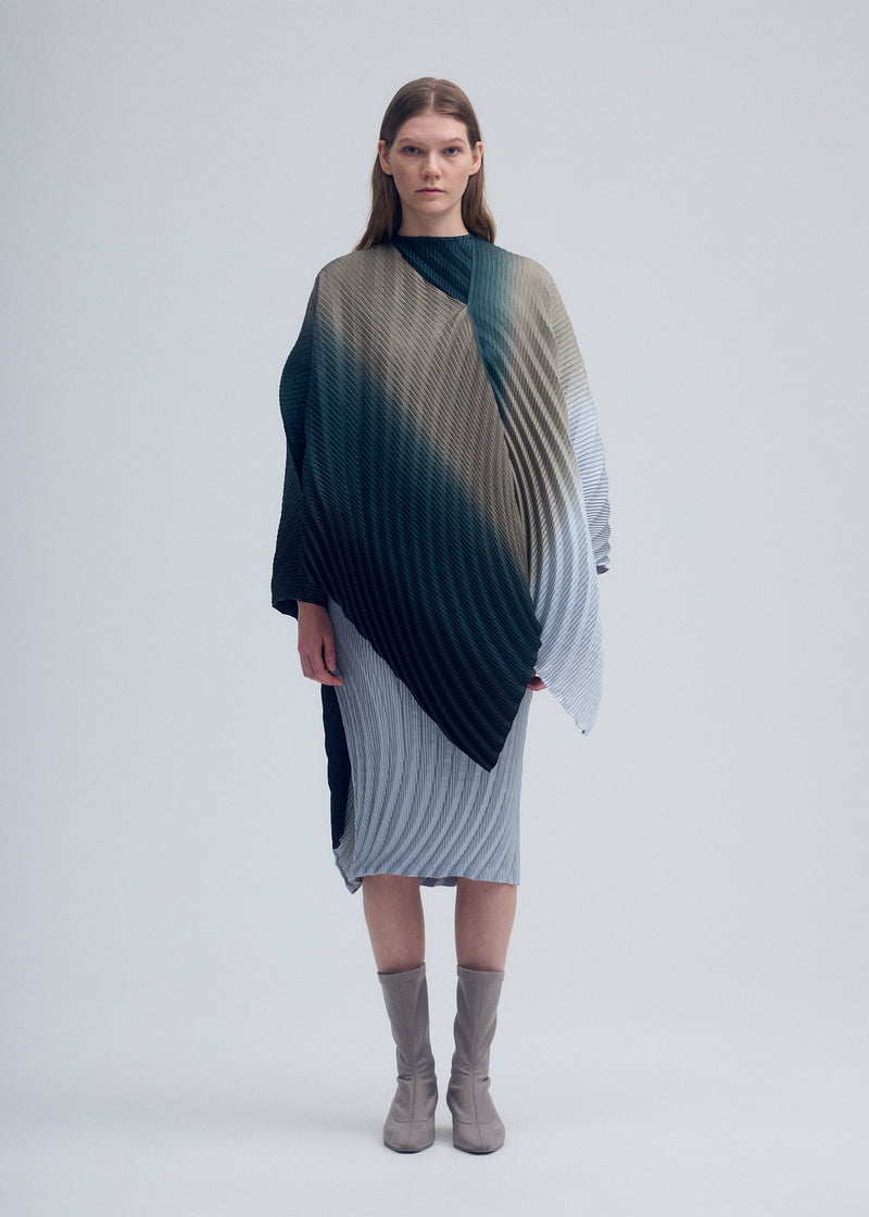 A model wears the ISSEY MIYAKE NUANCE PLEATS cardigan.