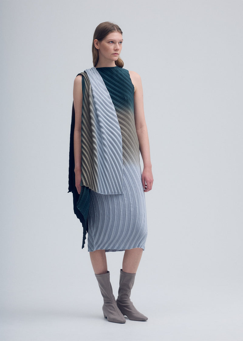 A model wears the ISSEY MIYAKE NUANCE PLEATS cardigan.