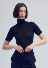 A model wears the ISSEY MIYAKE  SILK JERSEY top