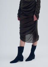 A model wears the ISSEY MIYAKE AMBIGUOUS WOOL skirt.