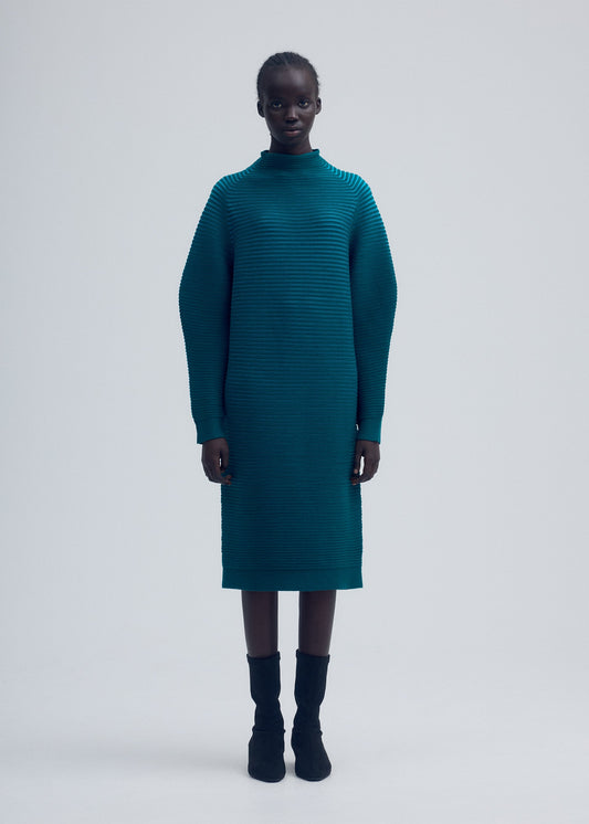 A model wears the ISSEY MIYAKE CIRCLE KNIT dress.