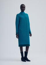 A model wears the ISSEY MIYAKE CIRCLE KNIT dress.