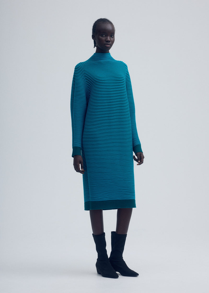 A model wears the ISSEY MIYAKE CIRCLE KNIT dress.