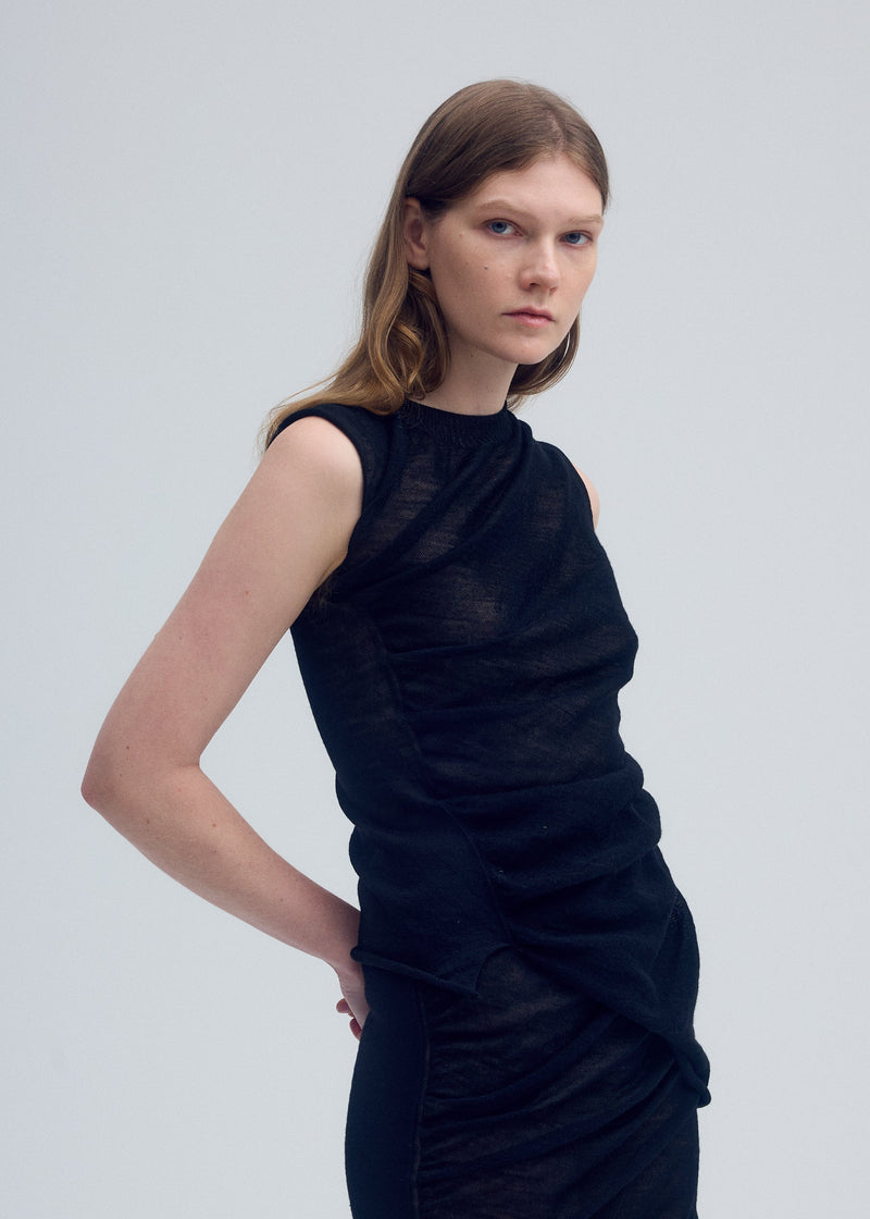 A model wears the ISSEY MIYAKE AMBIGUOUS WOOL top.