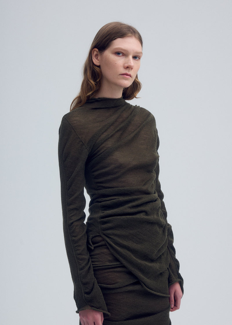 A model wears the ISSEY MIYAKE AMBIGUOUS WOOL top.