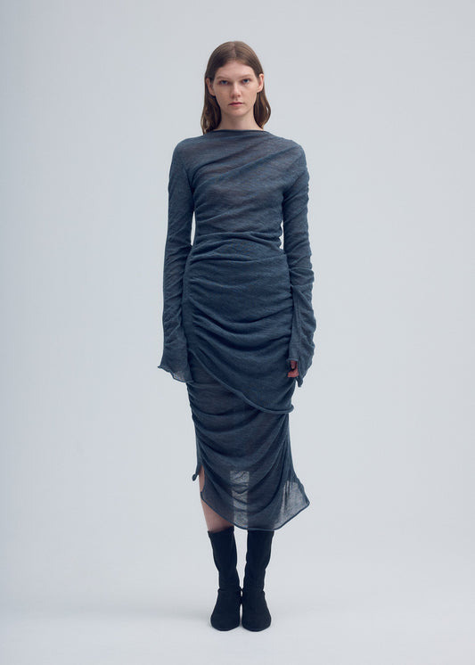 A model wears the ISSEY MIYAKE AMBIGUOUS WOOL tunic.