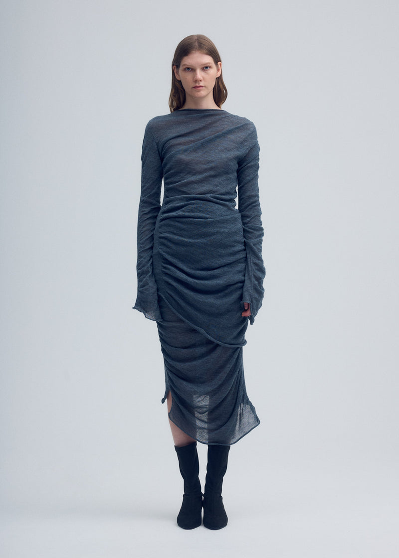 A model wears the ISSEY MIYAKE AMBIGUOUS WOOL tunic.