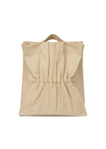 A product shot of the ISSEY MIYAKE DRAWN AND PRESSED bag in oaka beige (48).