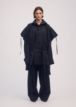 A model wears the ISSEY MIYAKE EASE AND EASED coat.