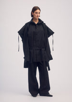 A model wears the ISSEY MIYAKE EASE AND EASED coat.