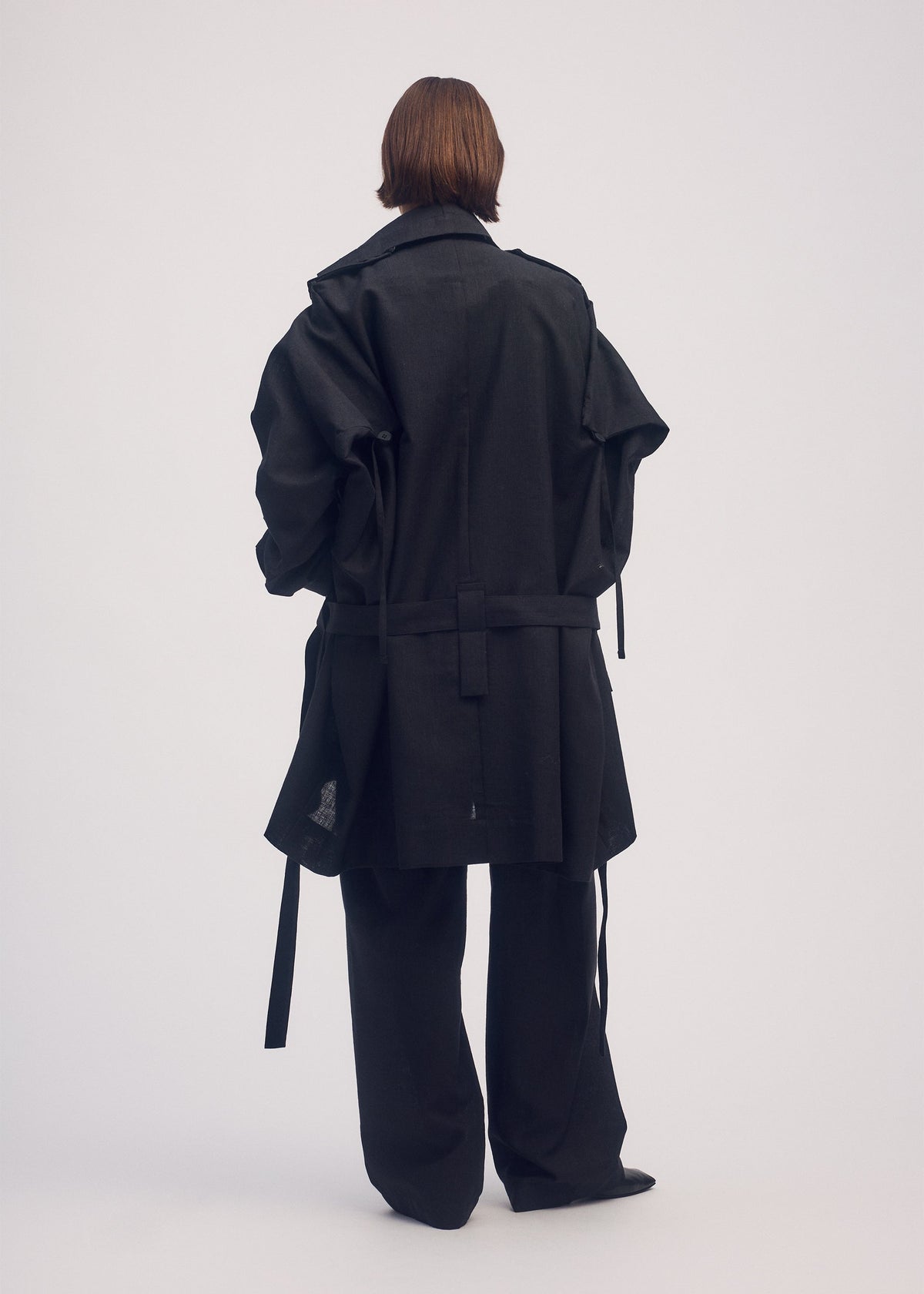 A model wears the ISSEY MIYAKE EASE AND EASED coat.