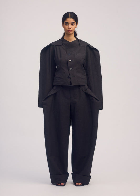 A model wears the ISSEY MIYAKE FOLD TO FORM jacket.