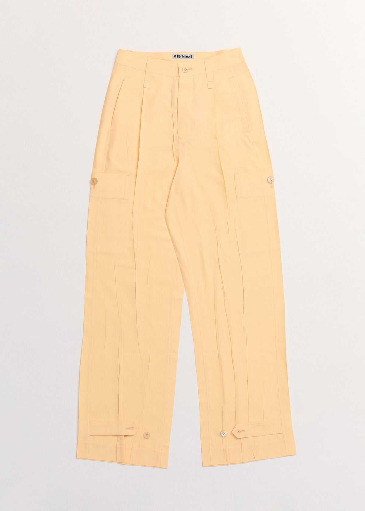 A detail shot of the ISSEY MIYAKE PRESSED FORM trousers.