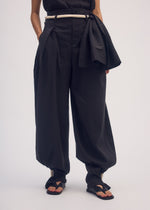 A model wears the ISSEY MIYAKE CLOTH AND CORD trousers.