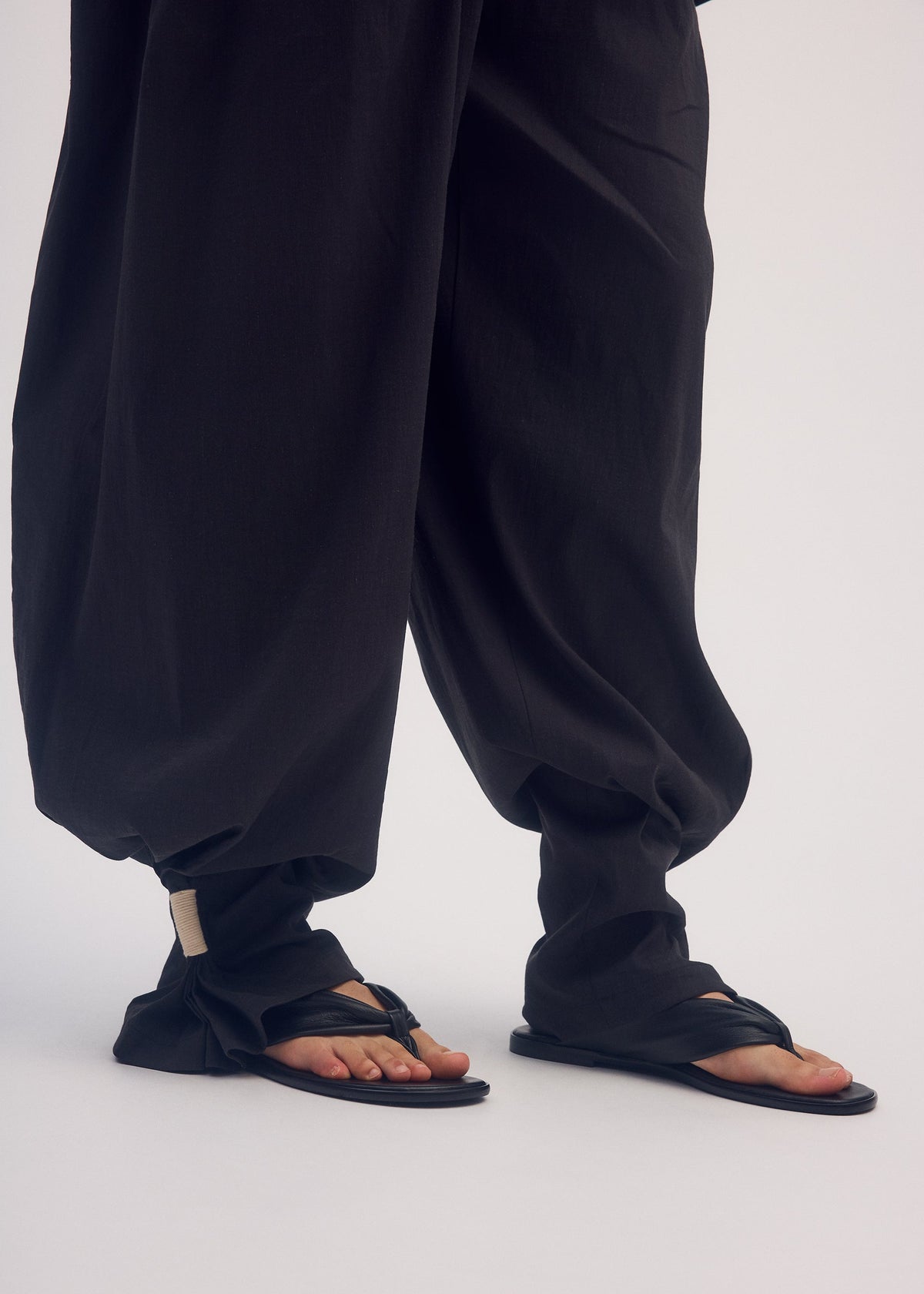 A model wears the ISSEY MIYAKE CLOTH AND CORD trousers.