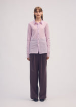 A model wears the ISSEY MIYAKE PERSONALITY PANTS trousers.