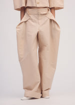 A model wears the ISSEY MIYAKE FOLD TO FORM trousers.