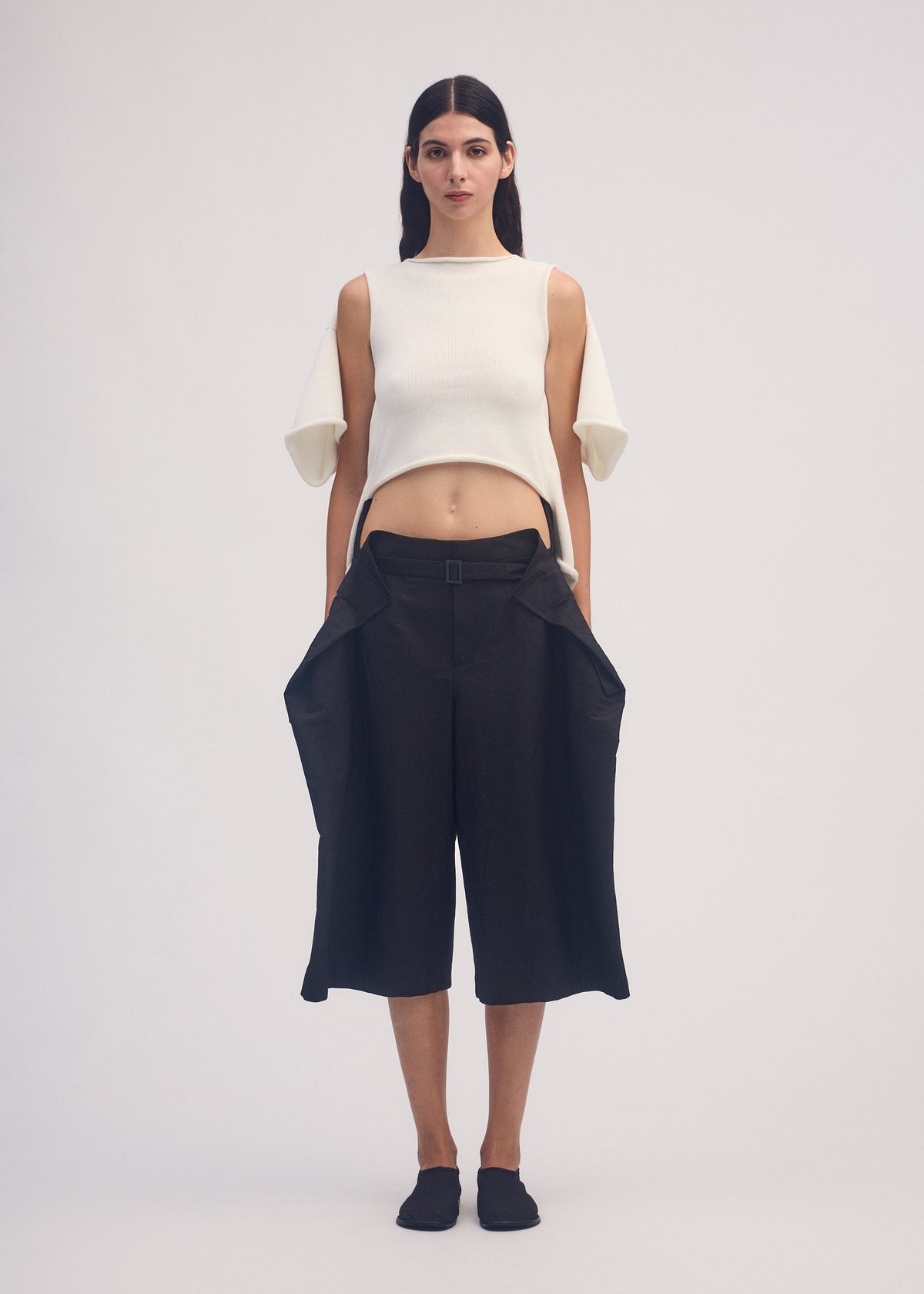 A model wears the ISSEY MIYAKE FOLD TO FORM trousers.