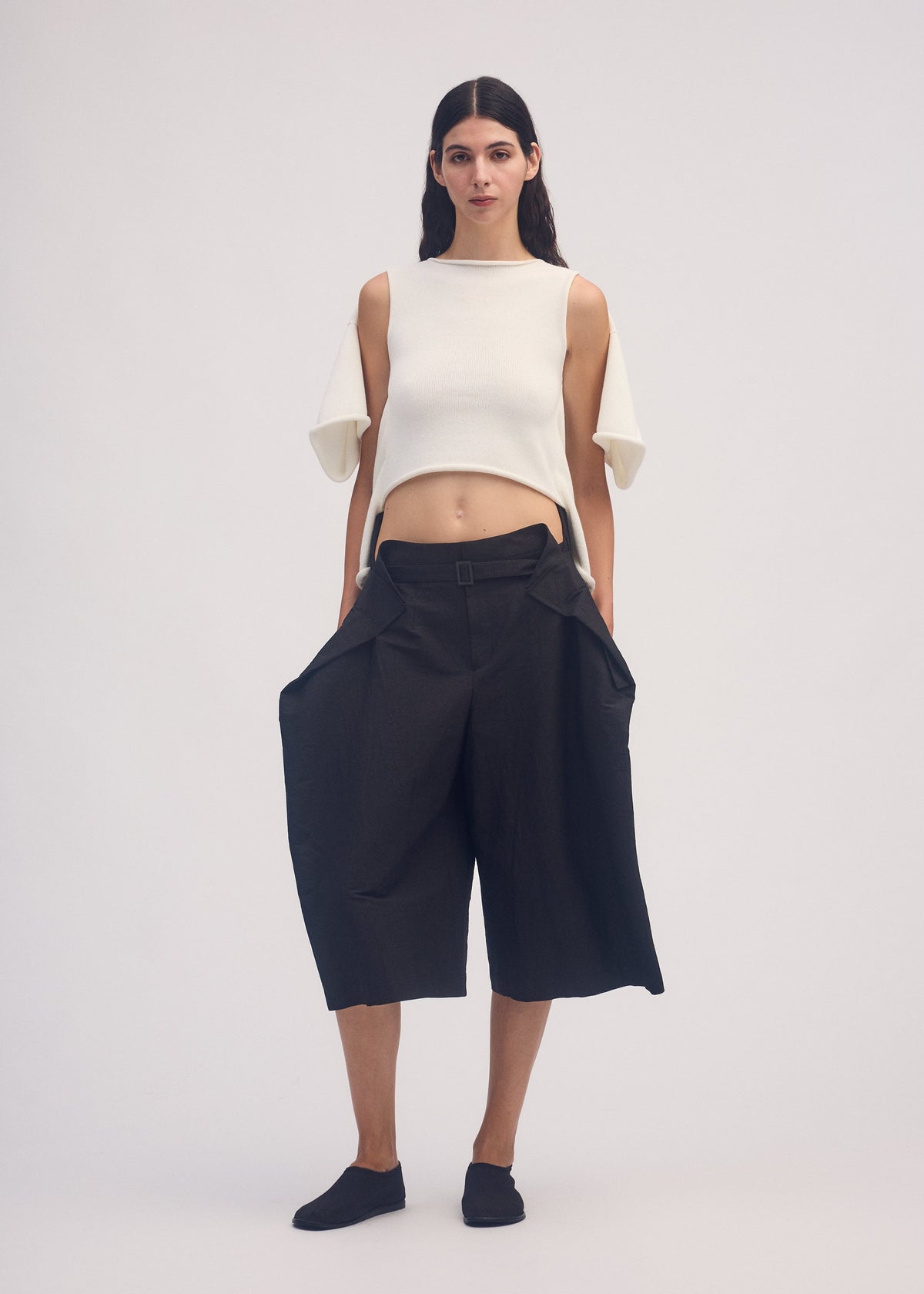 A model wears the ISSEY MIYAKE FOLD TO FORM trousers.